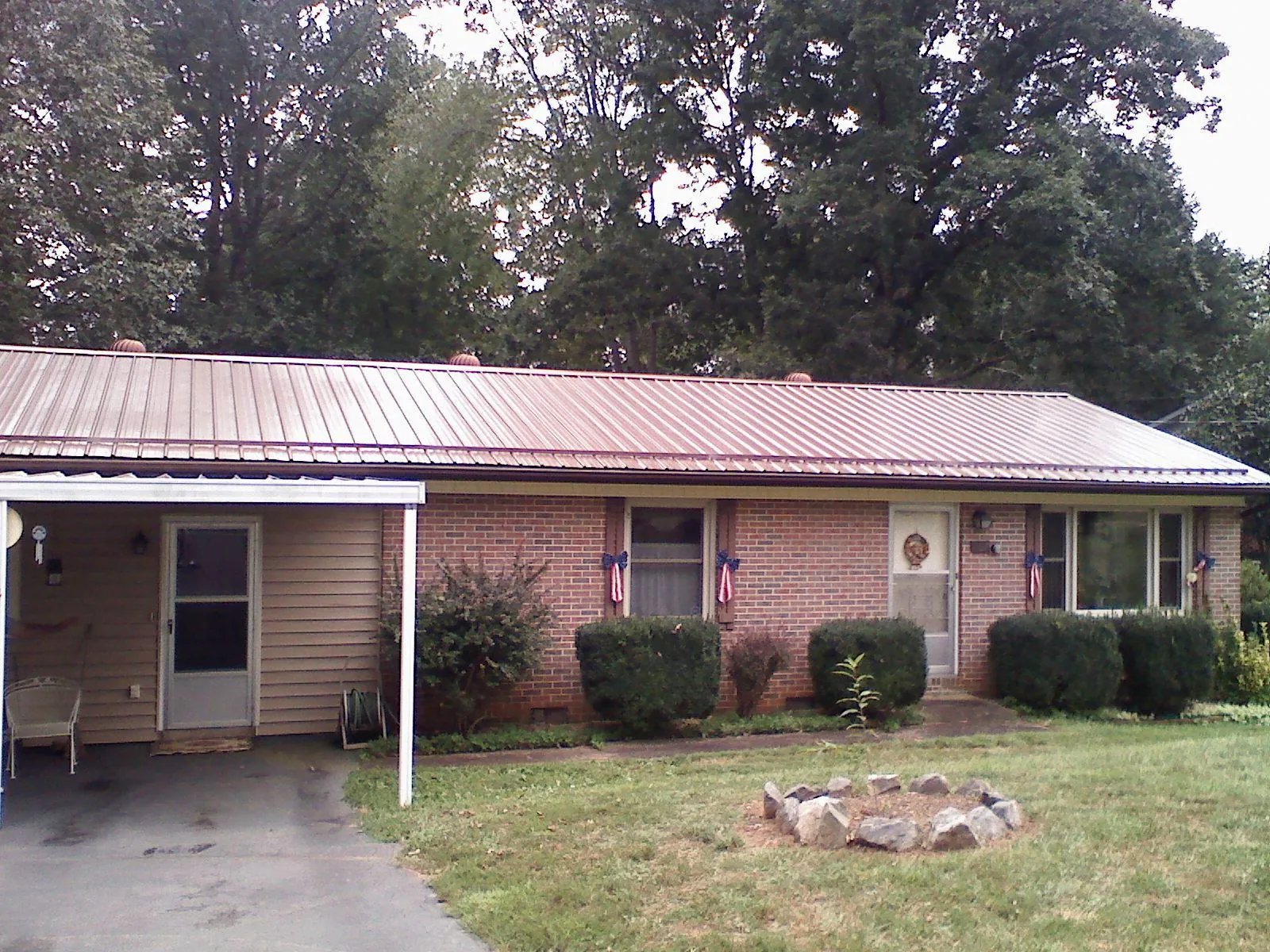 Bronze metal roof and carport on a brick ranch home — Roof Repair work by our crew in Chaska